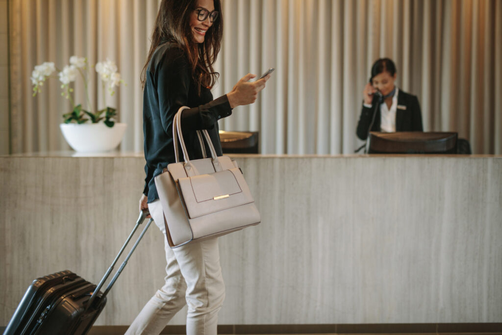 Guest arriving at a hotel reception with background music playing