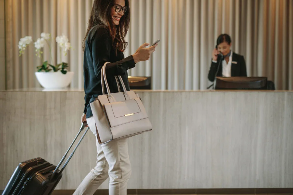 Guest arriving at a hotel reception with background music playing