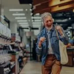 Shopper dancing in a supermarket aisle, showing how music lifts customer mood