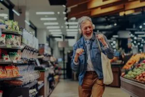 Shopper dancing in a supermarket aisle, showing how music lifts customer mood