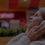 Woman listening to music in a shop, representing in-store radio for businesses