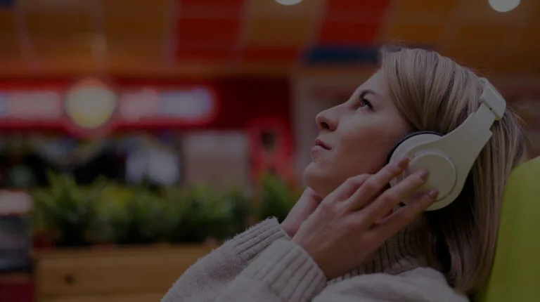 Woman listening to music in a shop, representing in-store radio for businesses