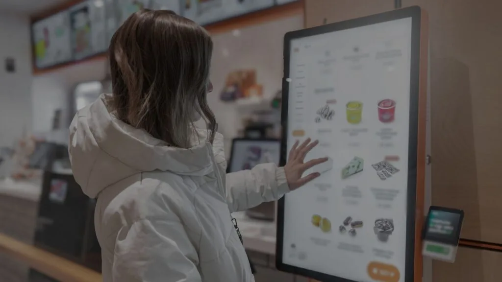 Customer using a digital signage screen at the point of decision
