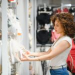 Young woman browsing through a retail store enjoying her shopping experience with DMX's retail sound systems