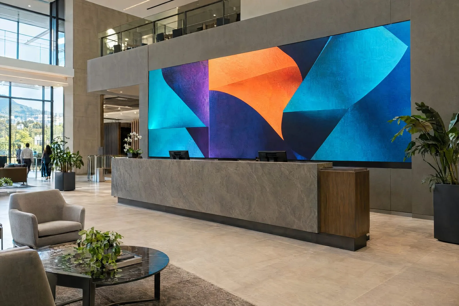 Indoor LED display screen behind a reception desk in a corporate lobby